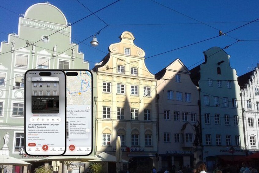 A smartphone displaying a map with a location marker, a street lamp, and historic buildings with signage. 1