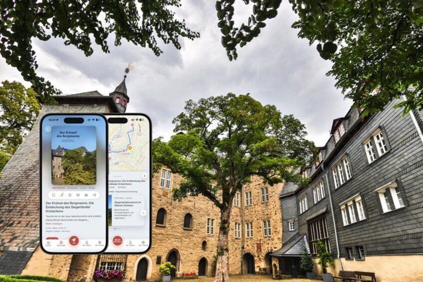 A historic building with a clock tower, surrounded by trees and a smartphone displaying a map. 1