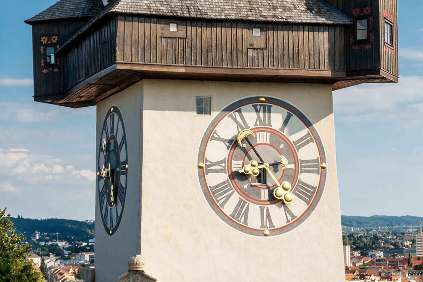 A clock tower with Roman numerals and a wooden structure on top. 5