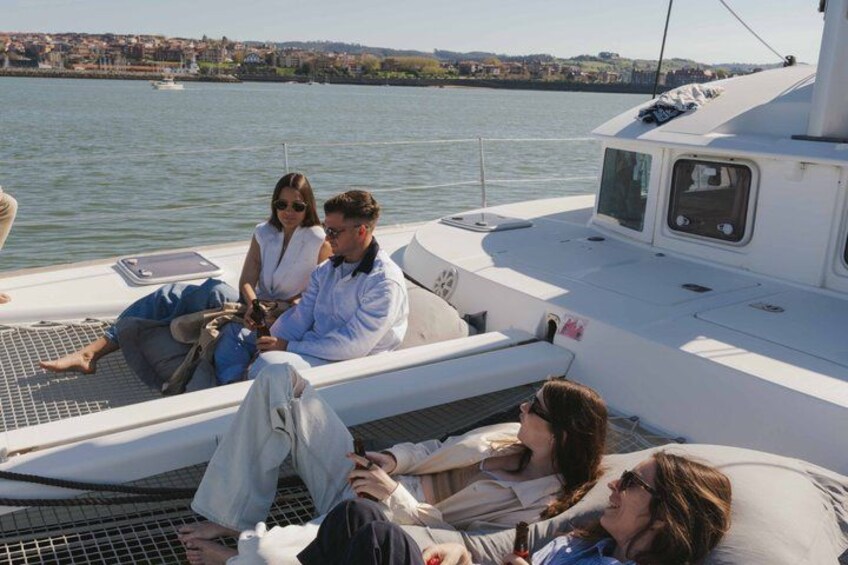 A group of people relaxing on a boat with a cityscape in the background. 5