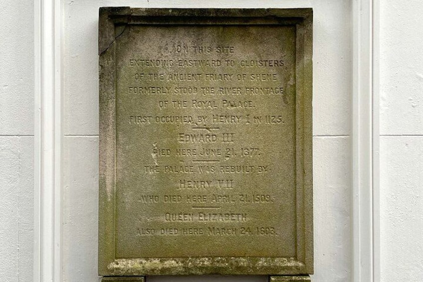A weathered stone plaque with historical inscriptions. 4