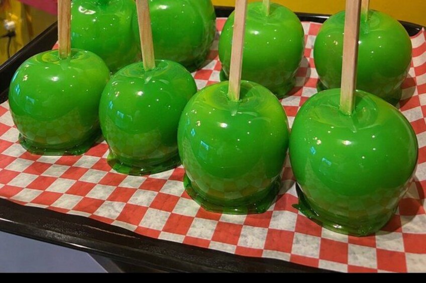 Green apple-shaped candies on a checkered paper. 3