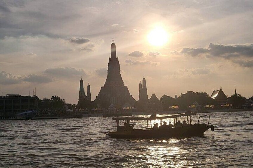 A boat on water with a temple in the background. 5