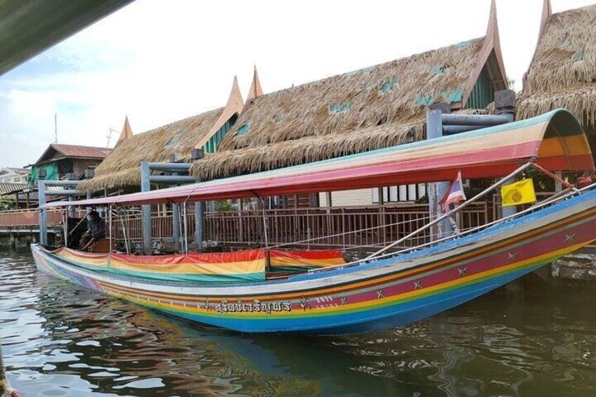 A colorful boat with a thatched roof structure in the background. 3