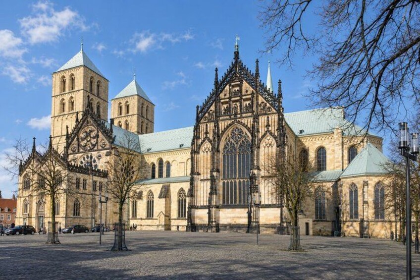 A historic cathedral with twin towers and a large central rose window. 5