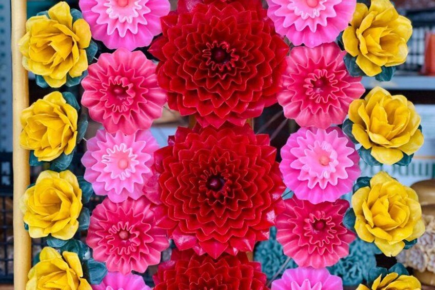 A collection of colorful artificial flowers arranged in a vertical pattern. 4