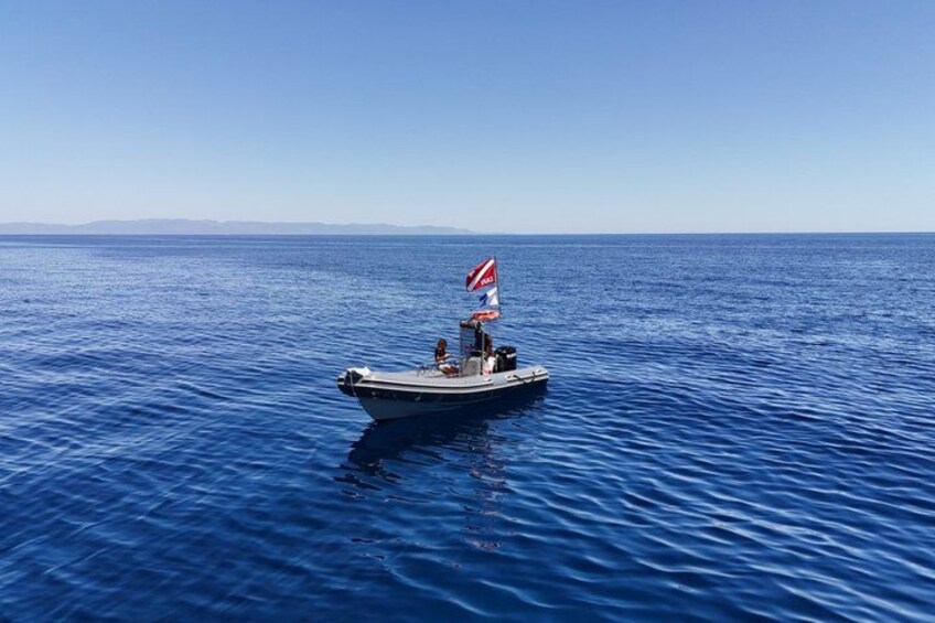 A small boat with a flag on a calm sea. 1