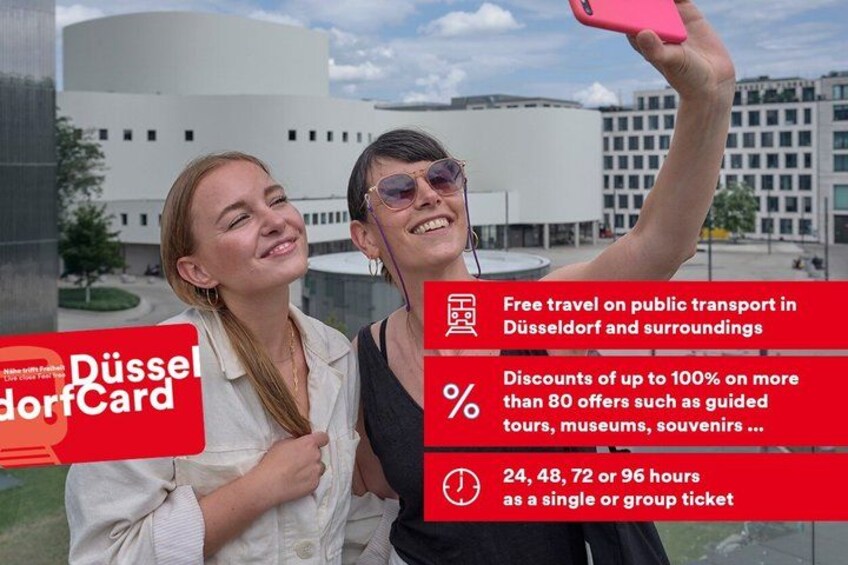 Two people taking a selfie with a modern building in the background. 1