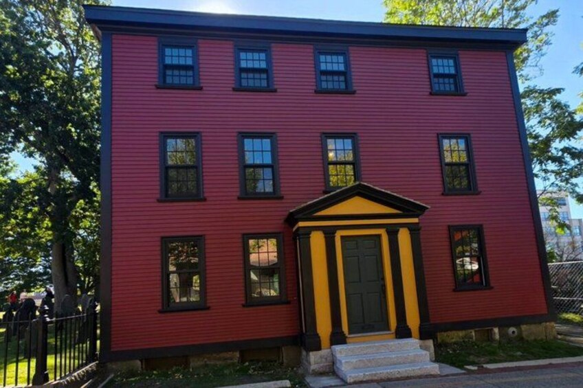 A red building with a yellow door and black trim. 5