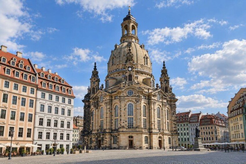 A historic church with a large dome and bell tower, surrounded by colorful buildings. 5