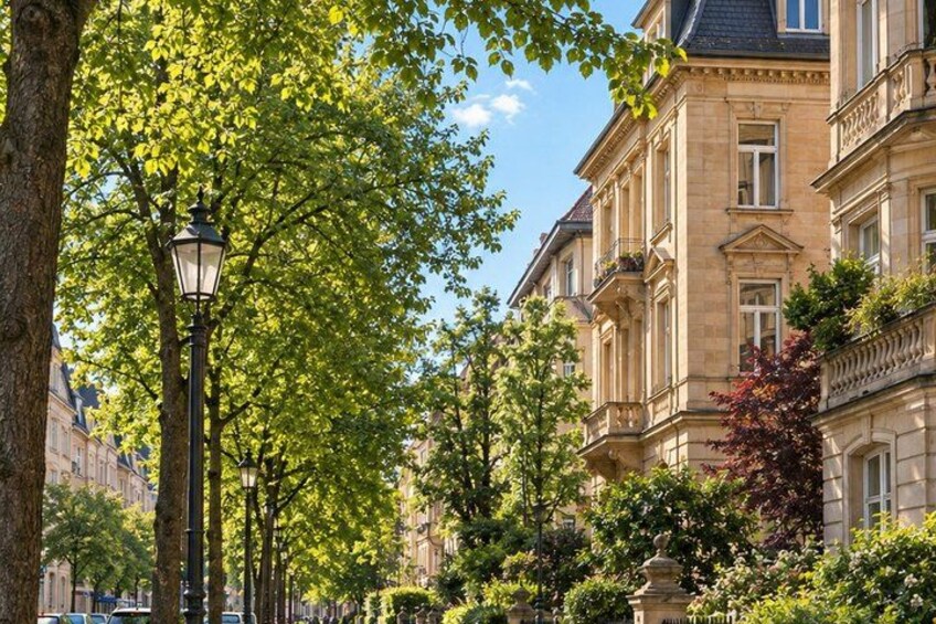 A street lined with trees and a historic building with balconies. 2