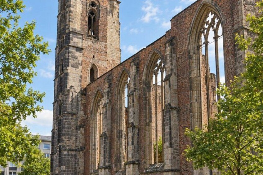 A historic church with tall brick towers and large arched windows. 3