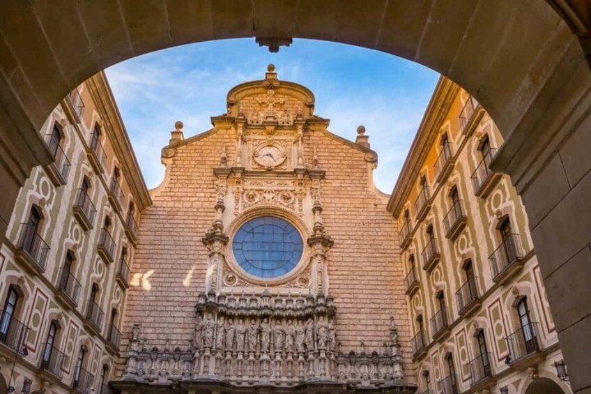 A historic building with ornate architecture, including a large circular window and detailed carvings. 5