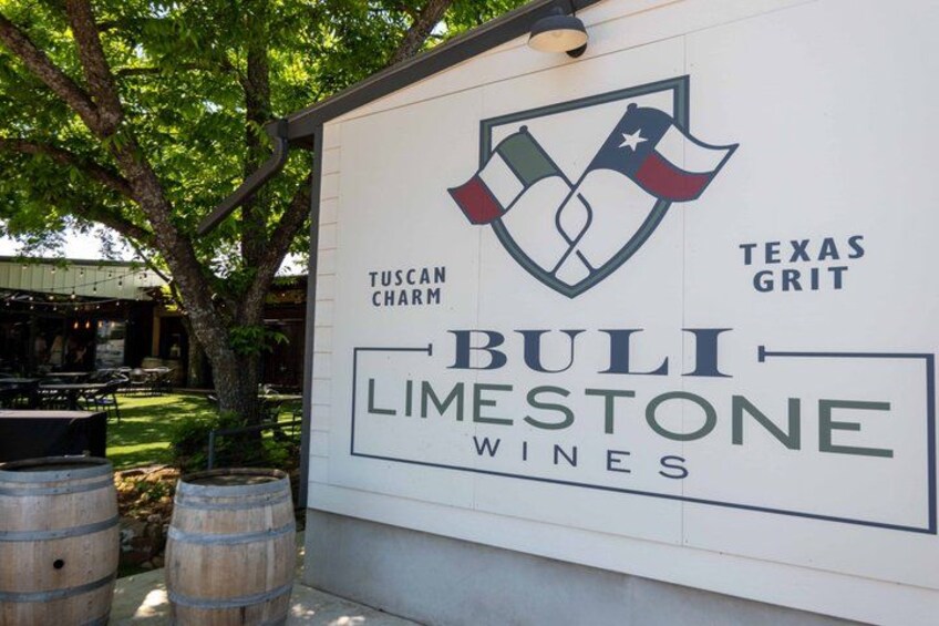 A sign for Buli Limestone Wines with a logo featuring a shield and flags. 4
