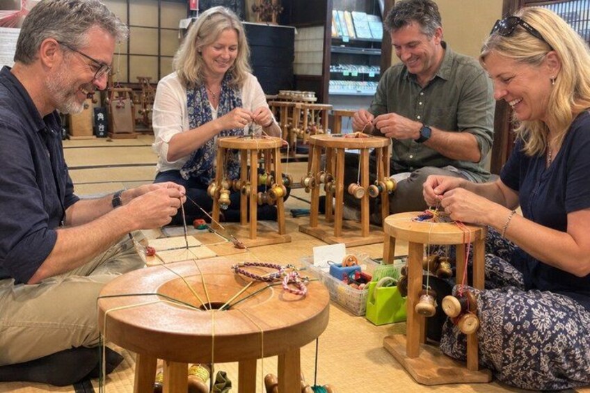 Four people engaged in a crafting activity, working with wooden tools and materials. 4