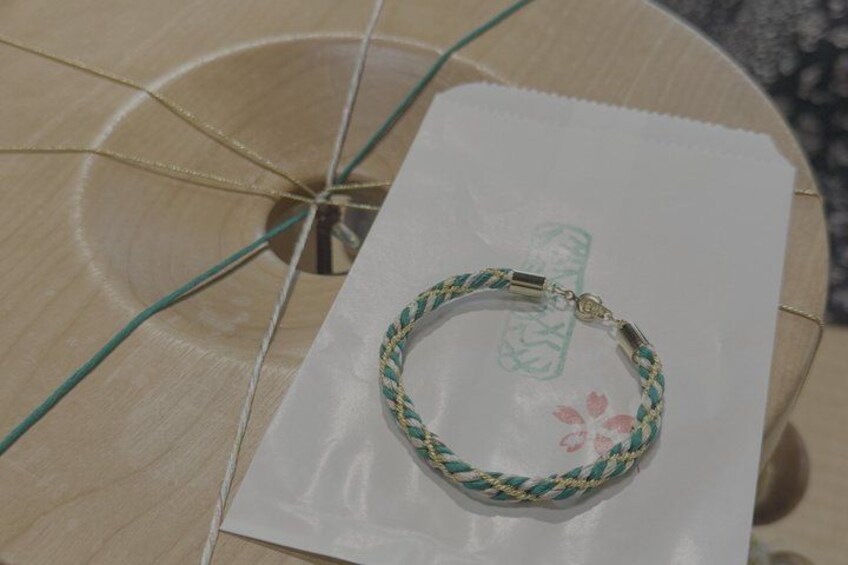A bracelet on a white paper with a floral design. 2