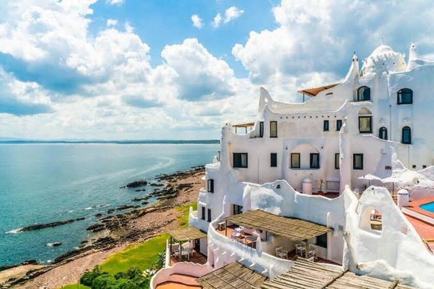 A white coastal building with a sea view. 3