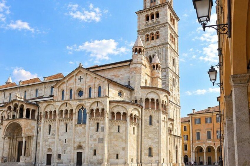 A historic building with a prominent tower, arched windows, and a clock. 3