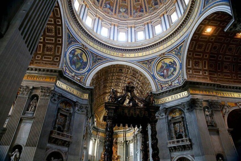 An ornate interior with a domed ceiling, detailed frescoes, and classical columns. 5