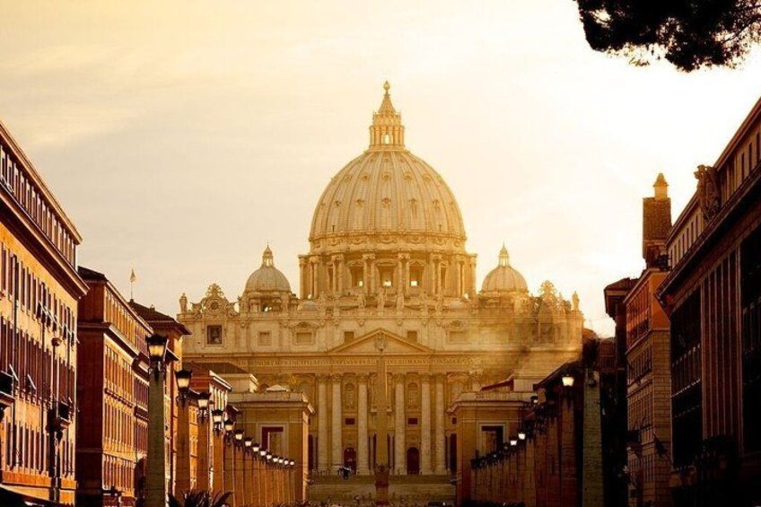 A grand historical building with a large dome, flanked by classical architecture. 1