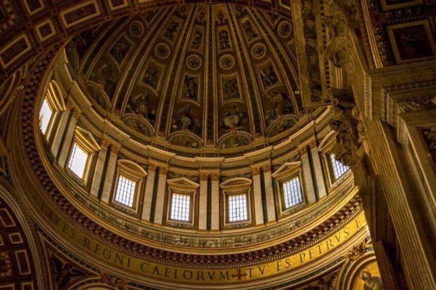 A grand architectural interior with a domed ceiling, intricate carvings, and classical columns. 4