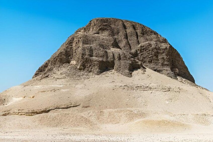 A large, isolated rock formation with a flat base and a steep, rocky peak. 5