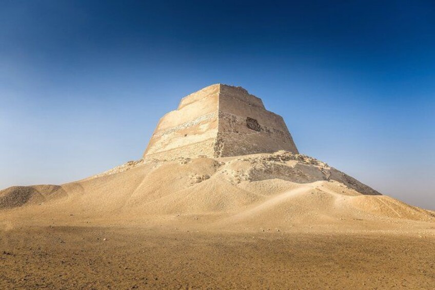 A large pyramid structure in a desert landscape. 1