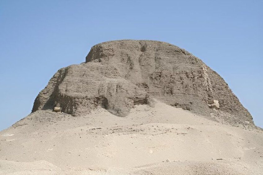 A large, isolated rock formation with a flat top and steep sides, surrounded by a barren landscape. 4