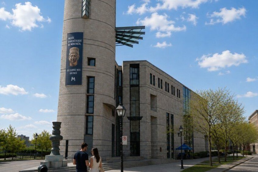 A modern building with a cylindrical tower, a large banner, and a clear sky. 3