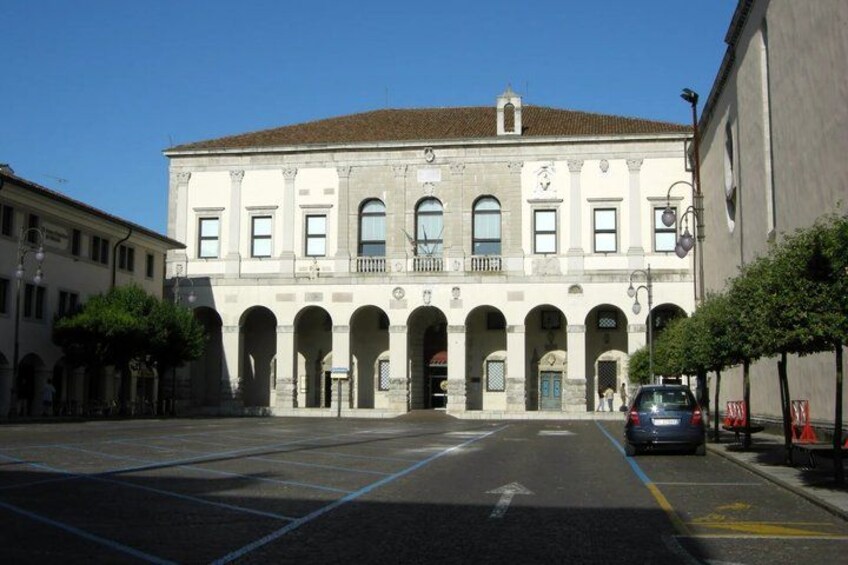 A historic building with a tiled roof and multiple arches. 5