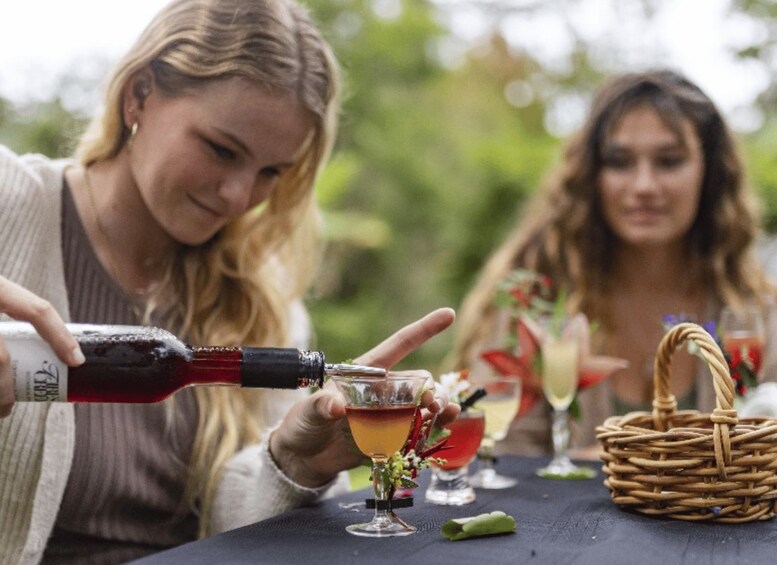 A person pouring a drink into a glass. 4