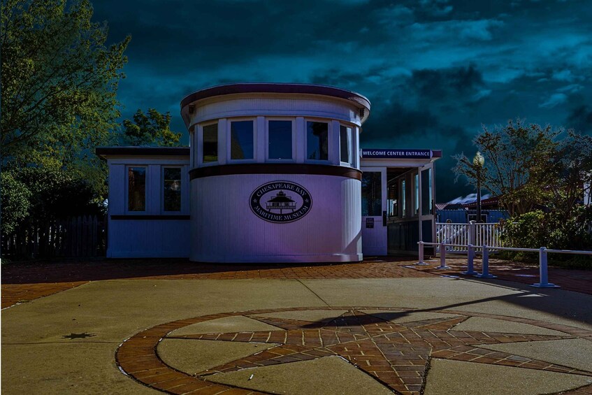 A maritime museum entrance with a circular building and a star-patterned walkway. 5