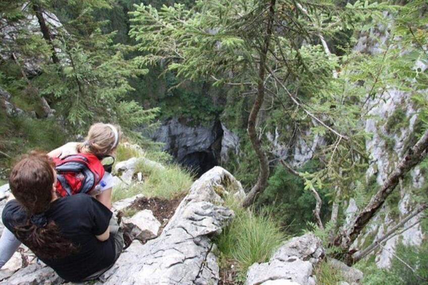 A person with a child on a rocky trail surrounded by trees. 3