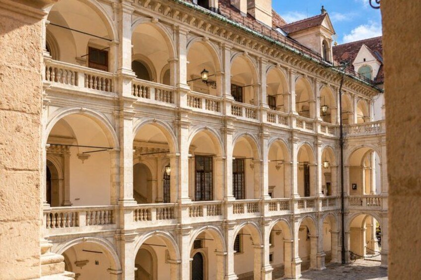 A multi-story building with arched windows and balconies. 5
