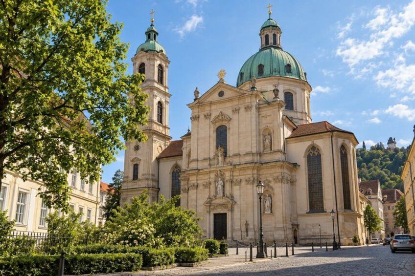 A historic church with two domes and a bell tower. 3