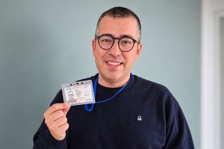 A person holding an ID card. 2