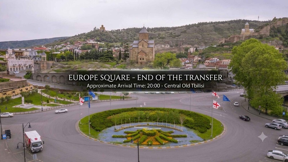 A cityscape with a prominent roundabout, a central square with a fountain, and a historic church on a hill. 3
