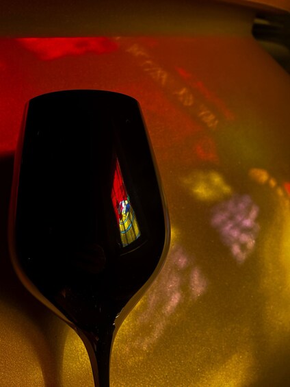 A wine glass with a reflection of a colorful object. 3