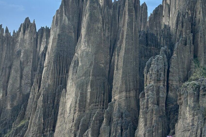 A rugged cliff face with vertical rock formations. 5