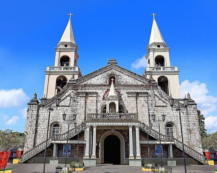 A historic church with two bell towers and a central entrance. 1