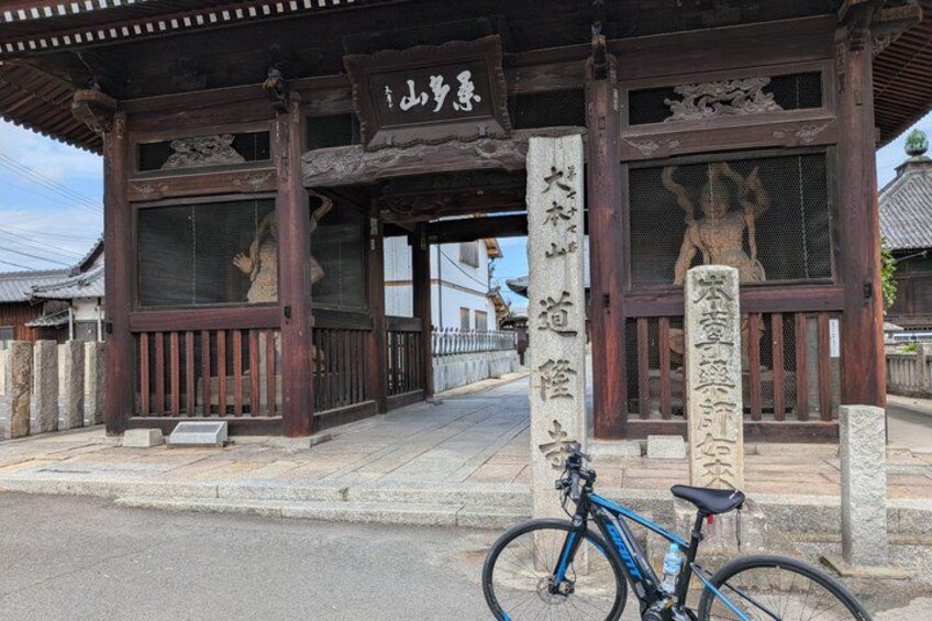 A traditional Japanese building with a bicycle parked in front. 4