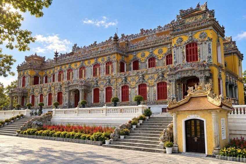A grand, ornate building with a yellow facade, red doors, and intricate architectural details. 5