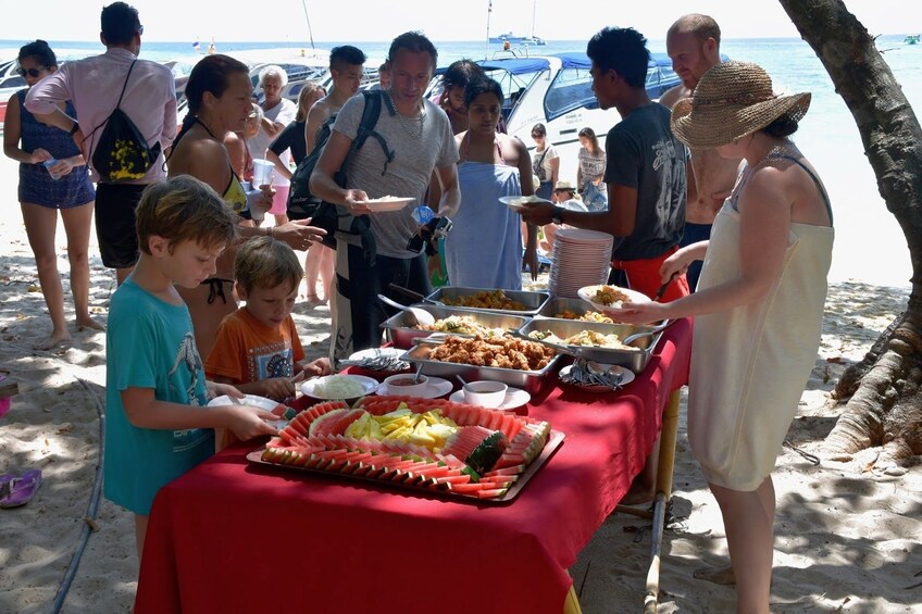 Group enjoying a Thai buffet lunch at Koh Rok Nok Beach