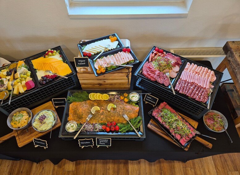 A variety of food items on a table, including cheese, meats, and vegetables. 1