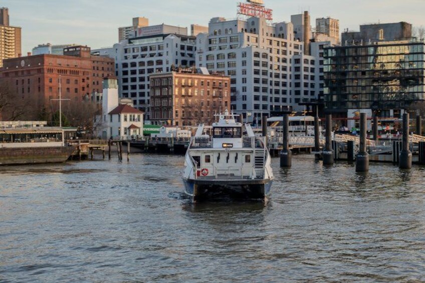 A river with a boat in the foreground and a cityscape in the background. 3