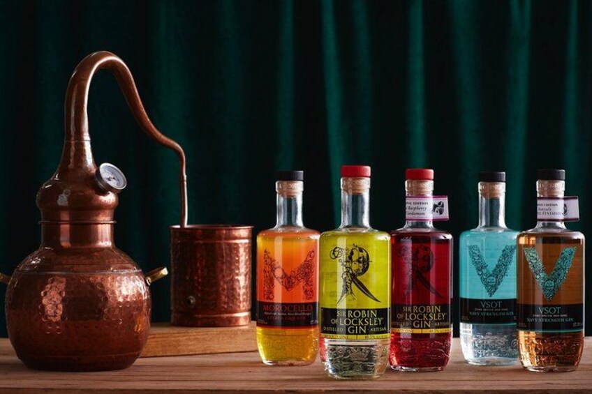 A copper still, six bottles of gin, and a wooden barrel. 1