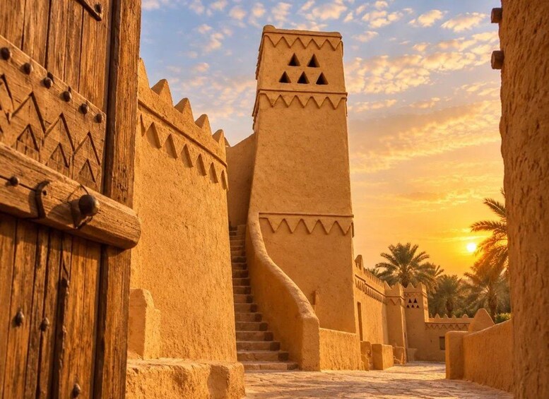 A desert landscape with a traditional mud-brick building, a wooden door, and palm trees. 2