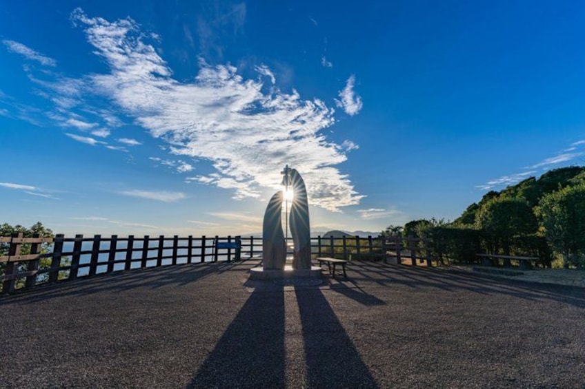A sculpture on a bridge with a clear sky. 1