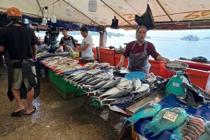 A fish market with people and fish on display. 4
