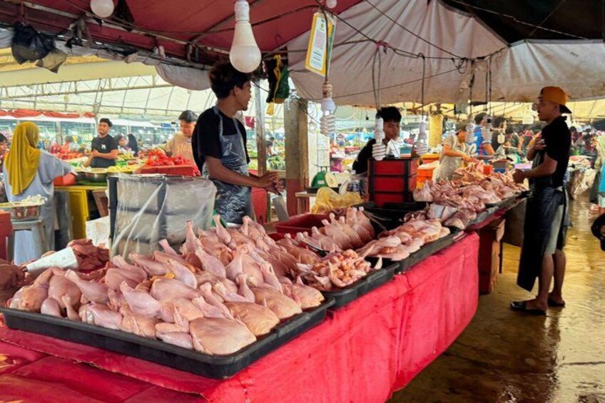 A market stall with various meats displayed on a table. 5